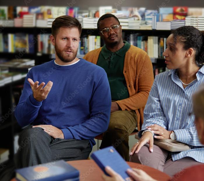 An adult teaching group in conversation